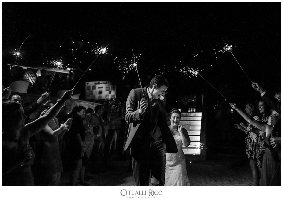 Guests holding sparklers for bride and groom funny photo