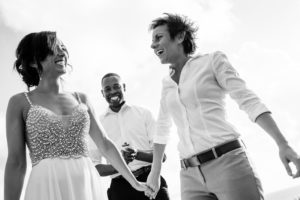 Two brides celebrating after their Isla Mujeres wedding ceremony