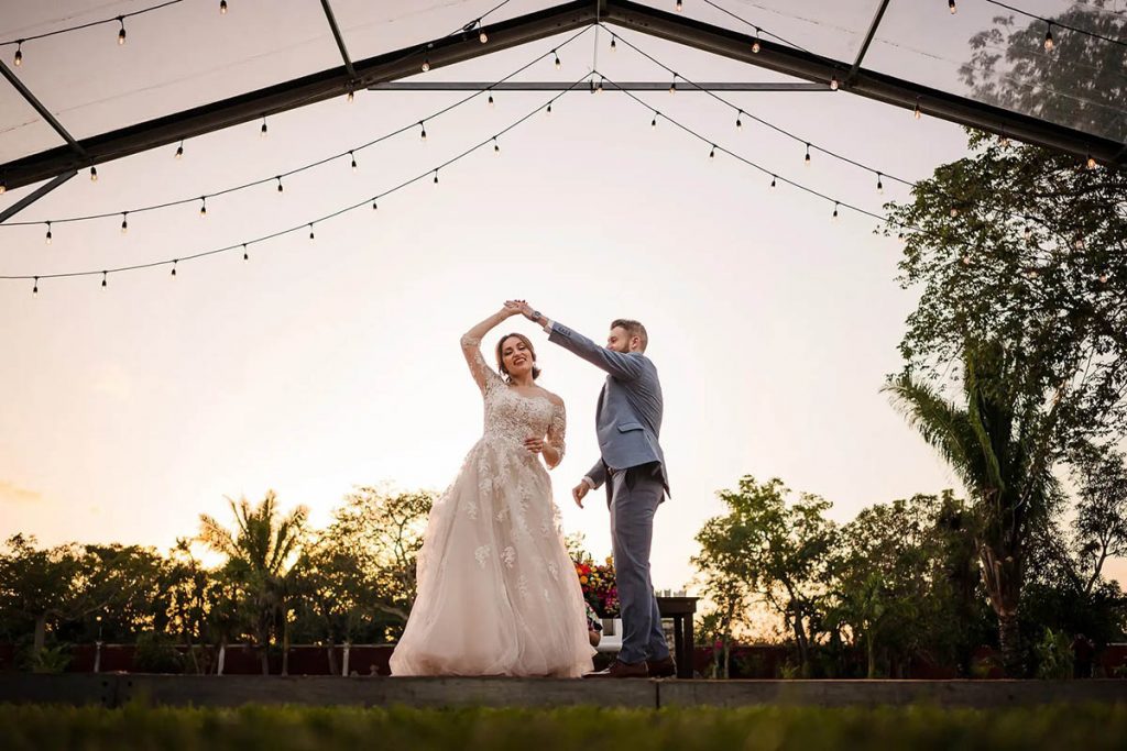 Bride and groom dancing in the grass - destination wedding photographer cancun Citlalli Rico